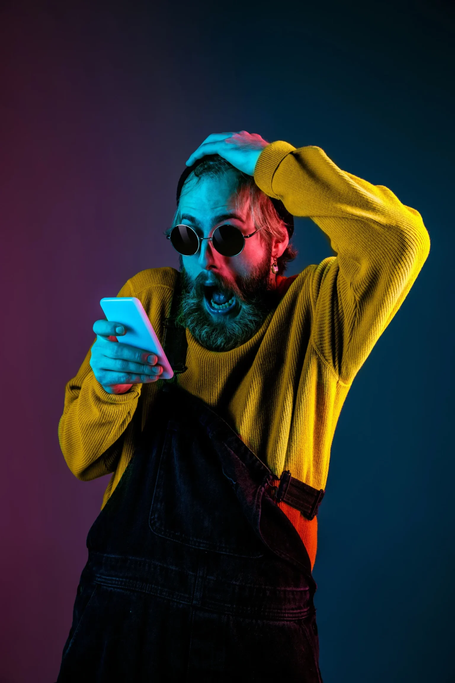 Caucasian man's portrait isolated on gradient studio background in neon light